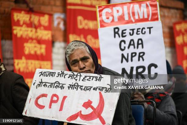 An activist of the Communist Party of India holds a placard during a demonstration against India's new citizenship law in New Delhi on December 30,...