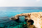 Bridge of Lovers rock formation on the rocky shore of the Mediterranean sea on the island of Cyprus Ayia NAPA. No people.