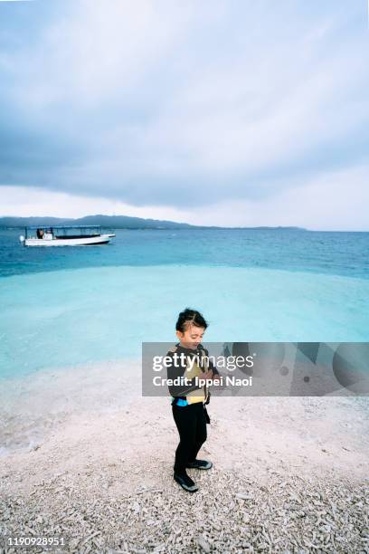 young girl beachcombing on coral cay while storm is approaching - typhoon lagoon stock pictures, royalty-free photos & images