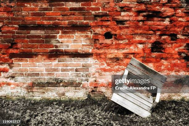 rickety old chair in front of ancient brick wall - porta palatina stock pictures, royalty-free photos & images