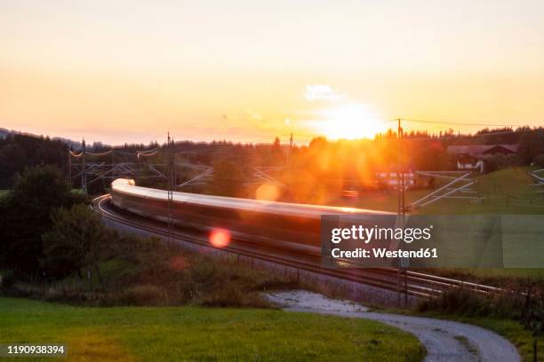 germany, upper bavaria, regional train at sunset - germany train stock pictures, royalty-free photos & images