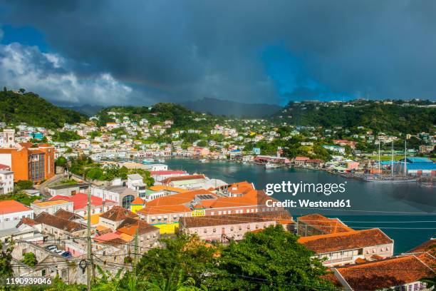 high angle view of residential district at st georges against cloudy sky, capital of grenada, caribbean - st george's harbour stock pictures, royalty-free photos & images