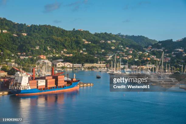 boats moored at st george's harbor against blue sky, grenada, caribbean - st george's harbour stock pictures, royalty-free photos & images