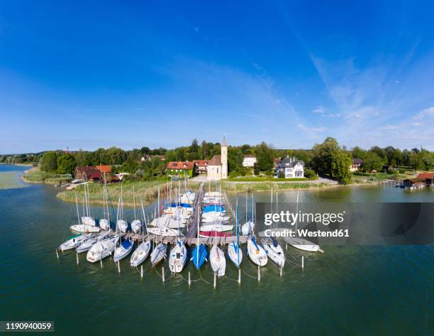 boats moored at jetty at lake ammersee in upper bavaria, germany - ammersee stock pictures, royalty-free photos & images