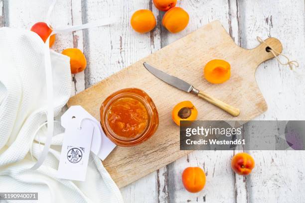 directly above shot of apricot jam on wooden table - aprikosenkonfitüre stock-fotos und bilder