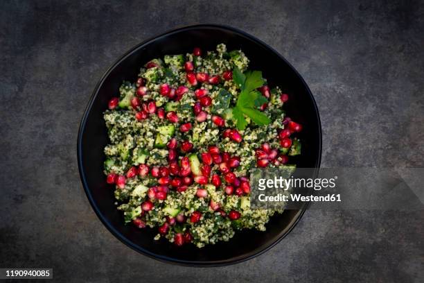 directly above shot of pomegranate salad served in plate on table - kuskus stock-fotos und bilder
