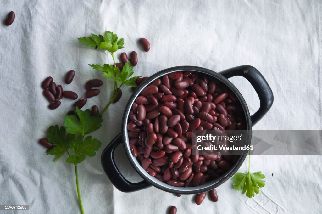 Directly above shot of kidney beans in cooking pan on tablecloth