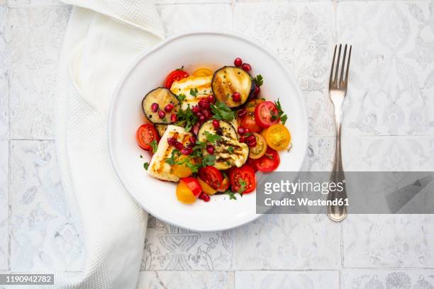 directly below shot of salad in plate by fork on floor - halloumi fotografías e imágenes de stock