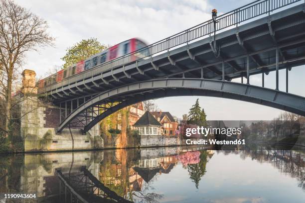 railway bridge over alster lake at hamburg, germany - hamburg stockfoto's en -beelden