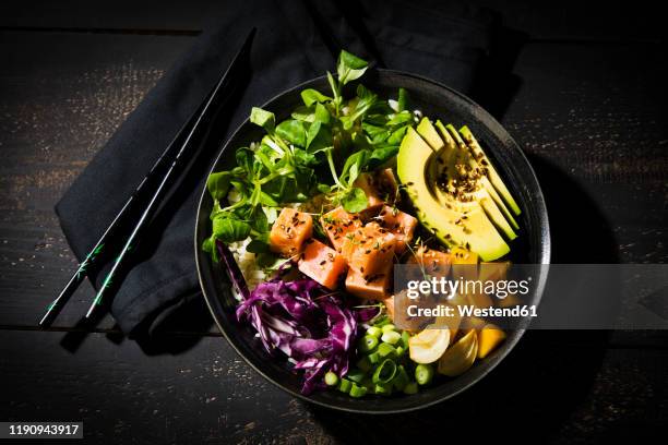 directly above shot of poke bowl with chopsticks on wooden table - pokes stock pictures, royalty-free photos & images