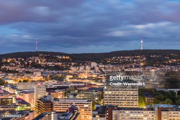 illuminated buildings and communications tower against cloudy sky at dusk in stuttgart, germany - fernsehturm stuttgart stock pictures, royalty-free photos & images