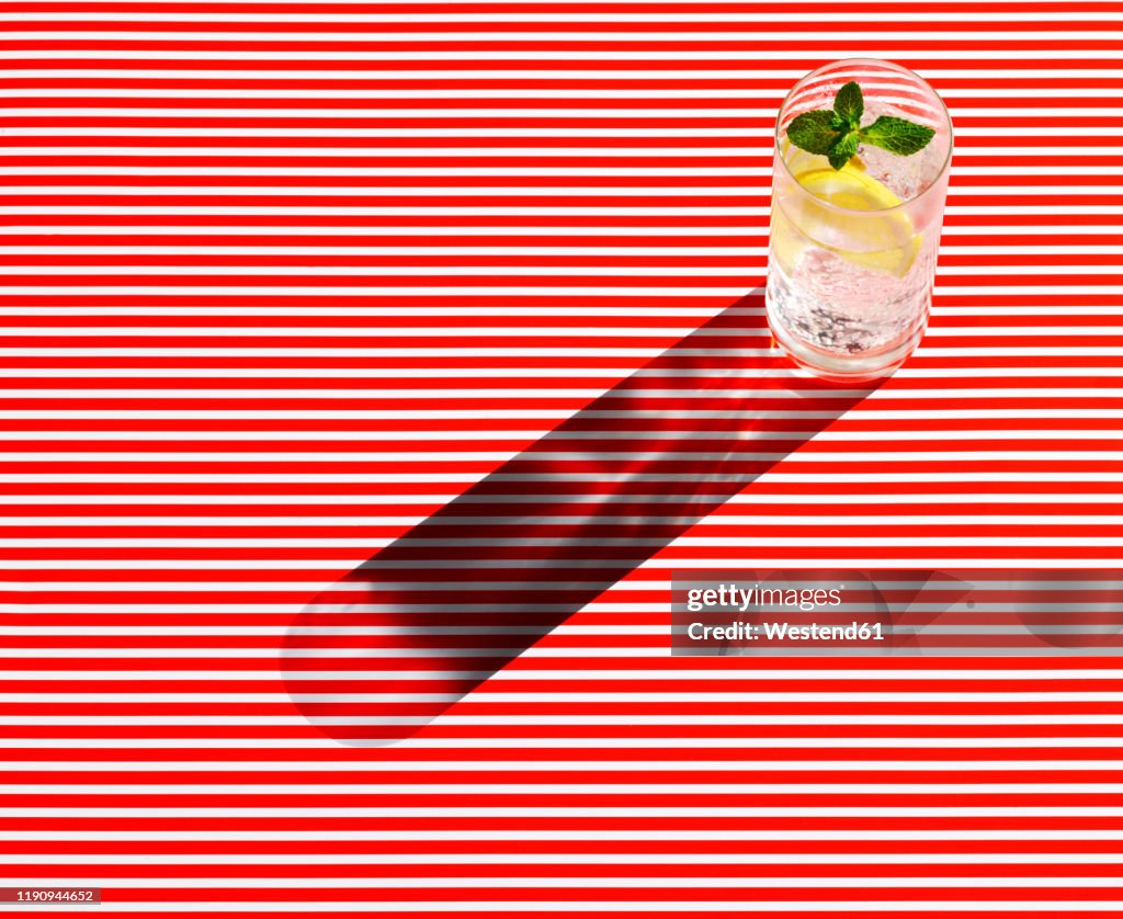 High angle view of gin served on striped table