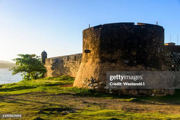 exterior of fortaleza san felipe against clear sky during sunset, puerto plata, dominican republic - puerto plata stock-fotos und bilder