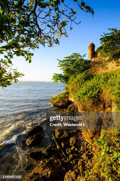 fortaleza san felipe by sea against clear sky during sunset, puerto plata, dominican republic - puerto plata stock pictures, royalty-free photos & images