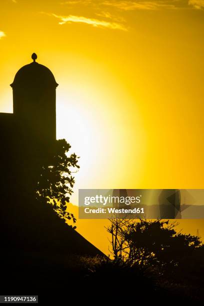 silhouette watchtower of fortaleza san felipe against sky at sunset, puerto plata, dominican republic - puerto plata imagens e fotografias de stock
