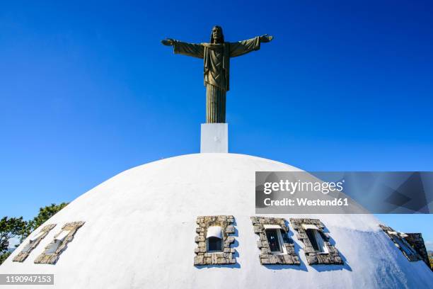 low angle view of christ the redeemer statue against clear blue sky during sunny day, puerto plata, dominican republic - puerto plata imagens e fotografias de stock