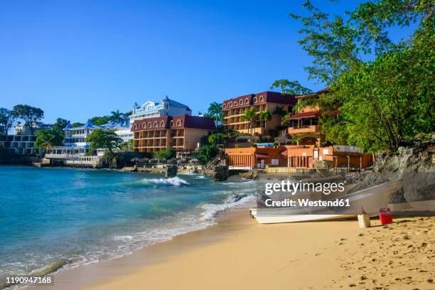 boats moored at beach against clear blue sky in sosa, dominican republic - puerto plata imagens e fotografias de stock