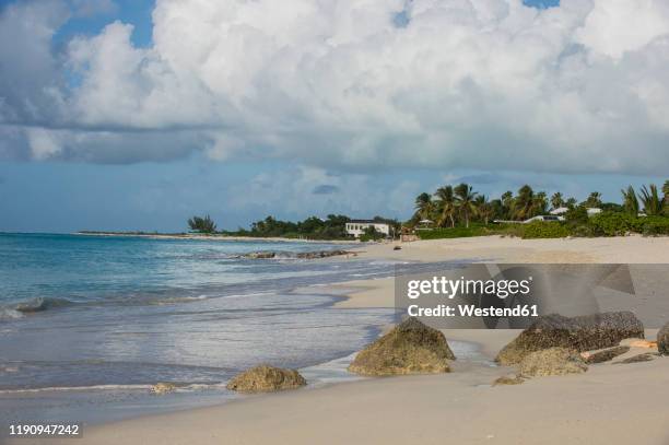 scenic view of grace bay beach against cloudy sky, providenciales, turks and caicos islands - providenciales stockfoto's en -beelden