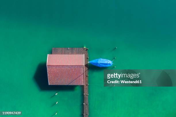 germany, bavaria, aerial view of boathouse standing on green shore of chiemsee lake - boathouse fotografías e imágenes de stock