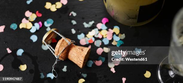 champagne cork surrounded by colorful confetti - champagne cork stock pictures, royalty-free photos & images