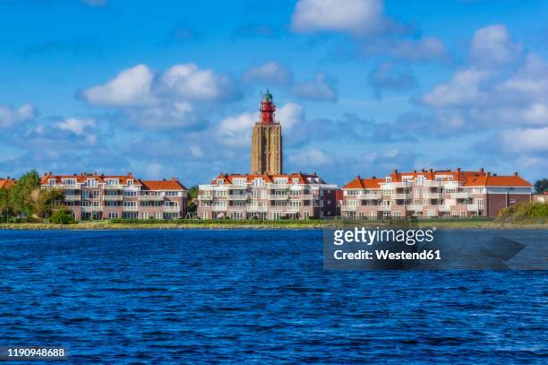netherlands, zeeland, westkapelle, cityscape with lighthouse - zeeland stock pictures, royalty-free photos & images