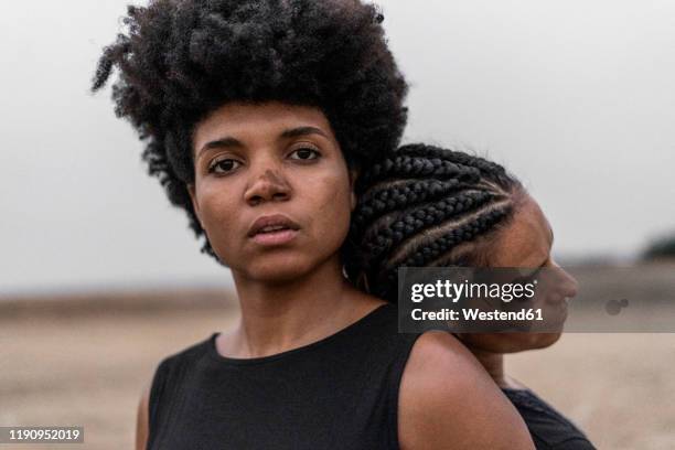 portrait of young woman with other woman at her back - mole stock pictures, royalty-free photos & images