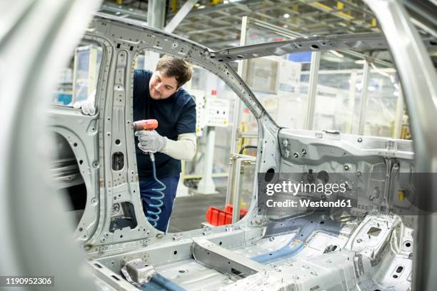 man working in modern car factory - autofabrik stock-fotos und bilder