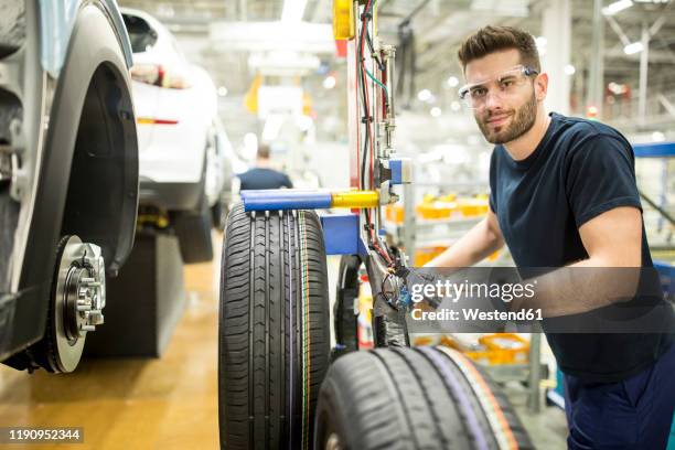 portrait of confident man working in modern car factory - content development stock pictures, royalty-free photos & images