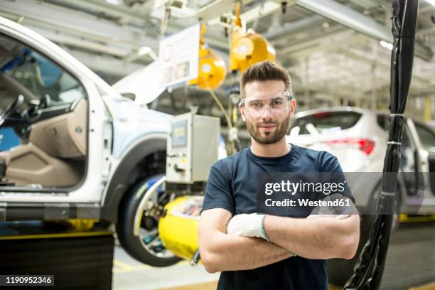 portrait of confident worker in modern car factory - auto cad stock pictures, royalty-free photos & images