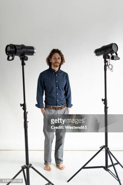portrait of a photographer in his studio - barefoot foto e immagini stock
