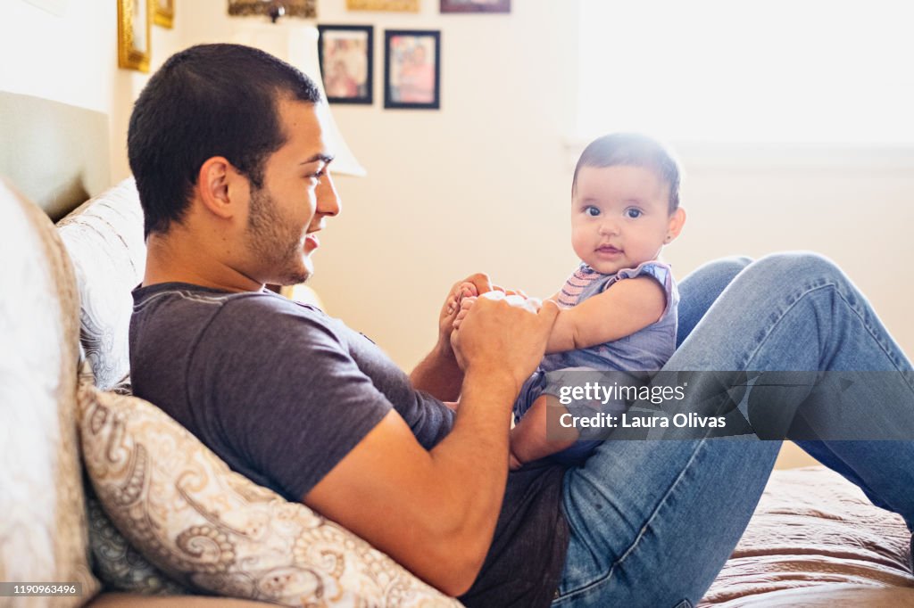 Young Father Being Playful With His Infant Daughter