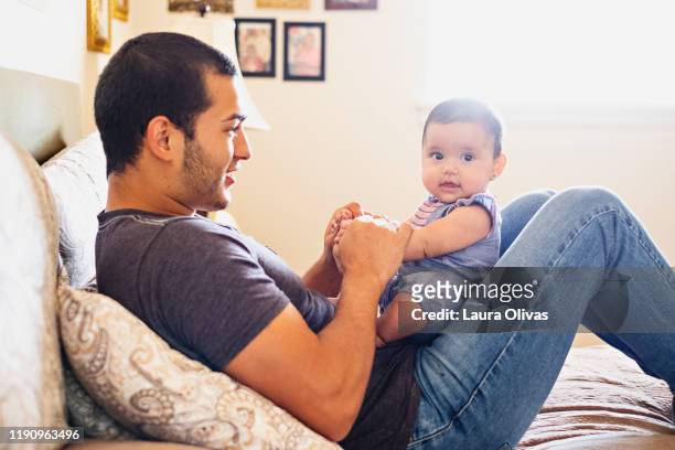Young Father Being Playful With His Infant Daughter