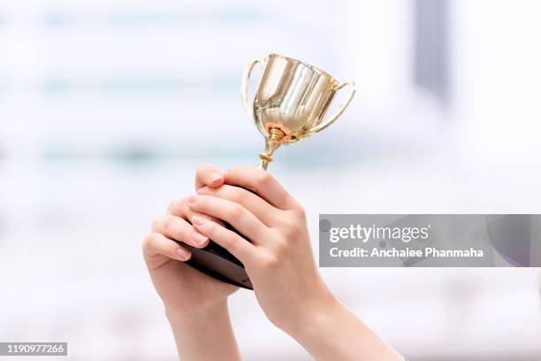 trophy in lady's hands - business awards ceremony stock pictures, royalty-free photos & images