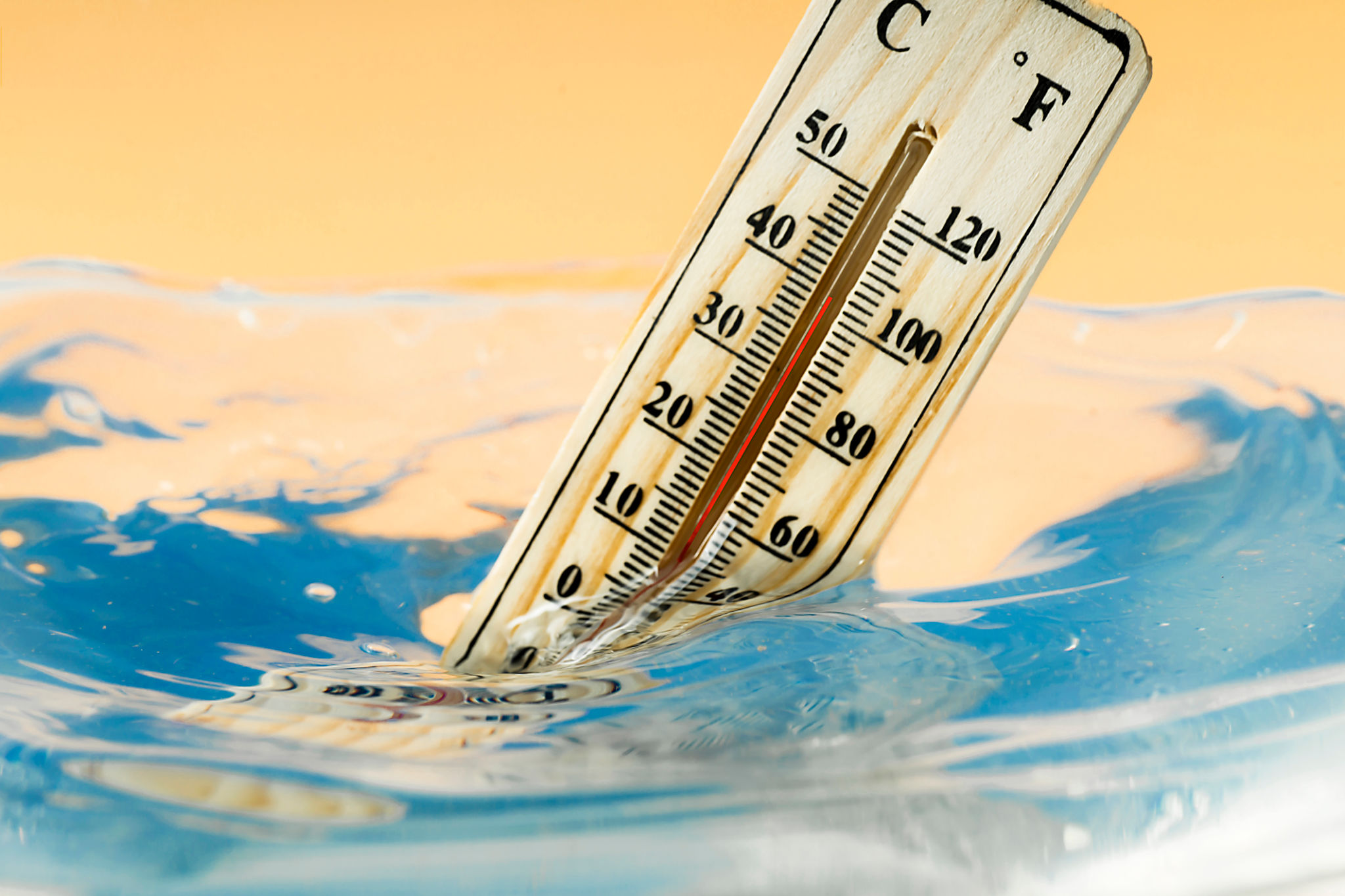 Climate change concept, thermometer immersed in water Climate change concept, thermometer immersed in water