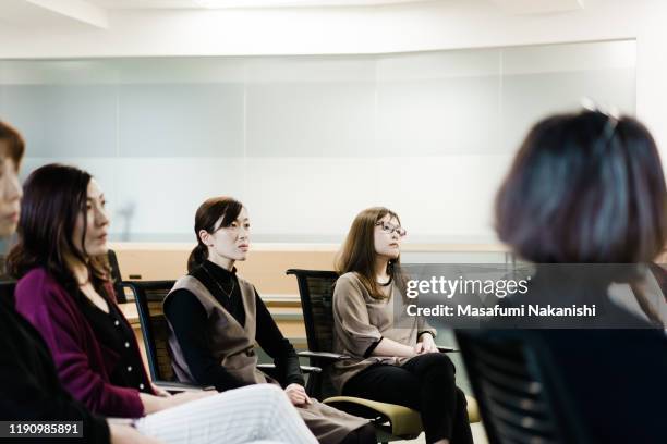 business woman listening to seminar - セミナー　日本人 ストックフォトと画像