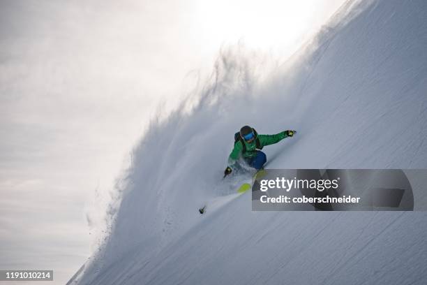 man skiing in powder snow, austrian alps, arlberg, salzburg, austria - freestyle skiing fotografías e imágenes de stock