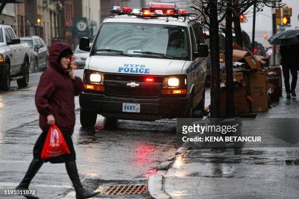 Car patrols in South Williamsburg Brooklyn on December 30, 2019 in New York City, two days after an intruder wounded five people at a rabbi's house...