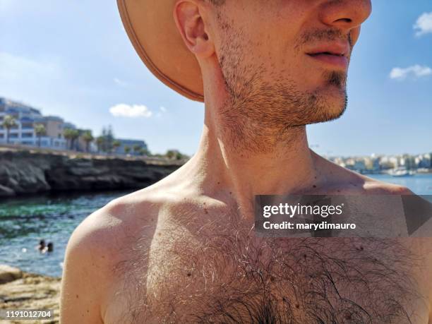 portrait of a man standing on beach, bugibba, malta - hairy chest fotografías e imágenes de stock