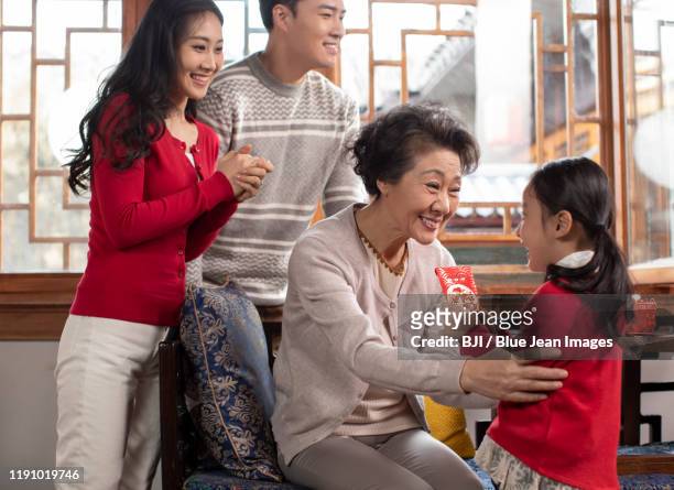 happy chinese family celebrating chinese new year - 25 year old man stock-fotos und bilder
