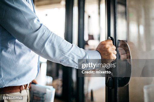 Businessman entering office cabin Businessman entering office cabin