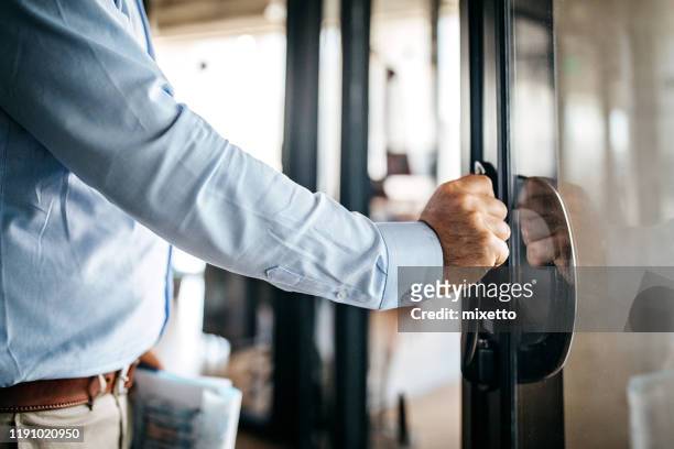 businessman entering office cabin - leaving stock pictures, royalty-free photos & images