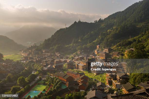 xijiang village at sunrise,guizhou,china - guizhou provincie stockfoto's en -beelden