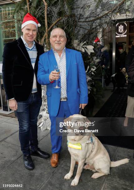 Martin Williams, CEO of M Group and Dave Kent with his guide dog, pose as M Restaurant Victoria Street hosts a Christmas Guide Dog Brunch with The...