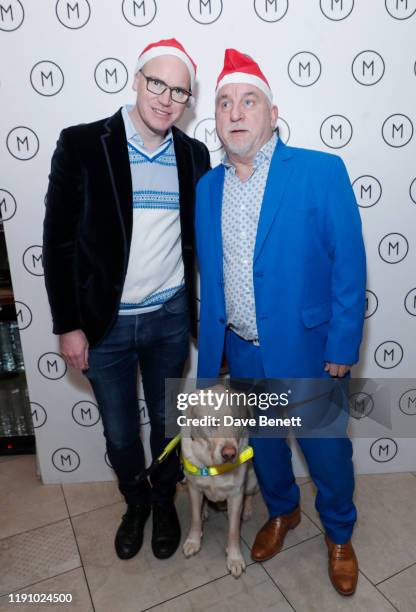 Martin Williams, CEO of M Group and Dave Kent with his guide dog, pose as M Restaurant Victoria Street hosts a Christmas Guide Dog Brunch with The...