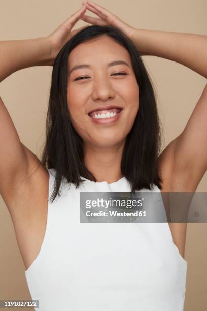 portrait of young female chinese woman - arm pit ストックフォトと画像