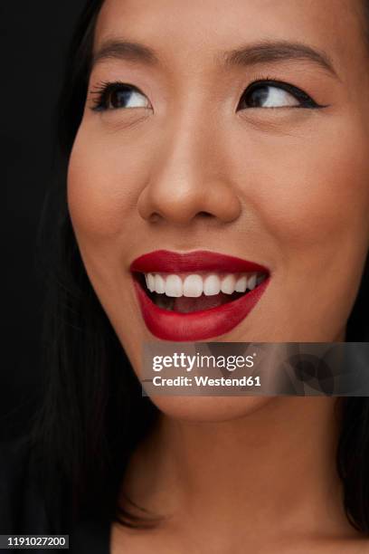 portrait of young female chinese woman with red lips, looking up - 赤の口紅 ストックフォトと画像
