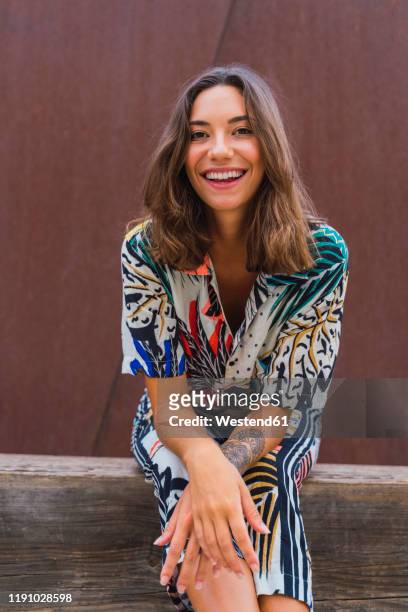 portrait of laughing young woman - multi colored blouse ストックフォトと画像