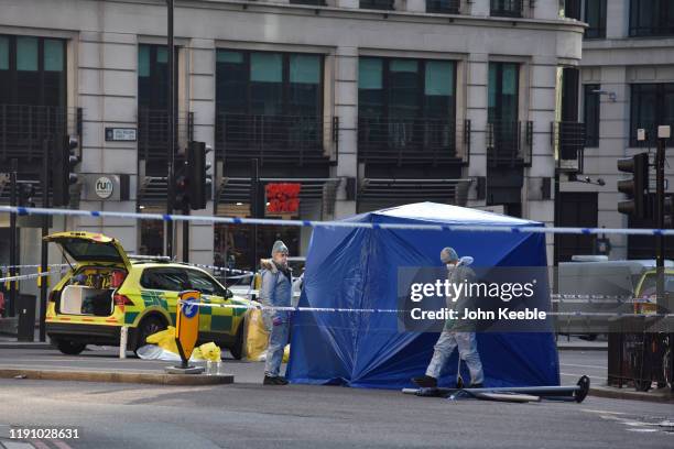 Forensic officers investigate the scene of yesterday's London Bridge stabbing attack on November 30, 2019 in London, England. A man and a woman were...