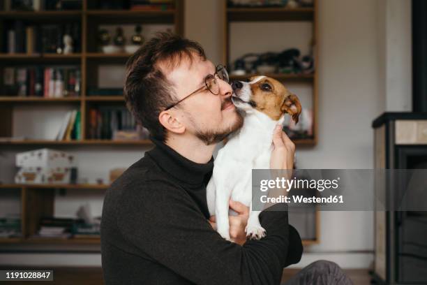 young man with jack russel terrier, licking - no ordinary love stock pictures, royalty-free photos & images