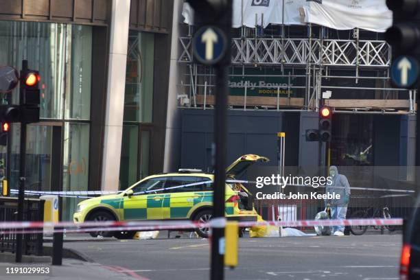 Forensic officers investigate the scene of yesterday's London Bridge stabbing attack on November 30, 2019 in London, England. A man and a woman were...